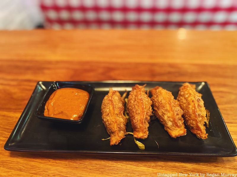 Four crispy braised oxtail dumplings and black garlic dipping sauce from RedFarm