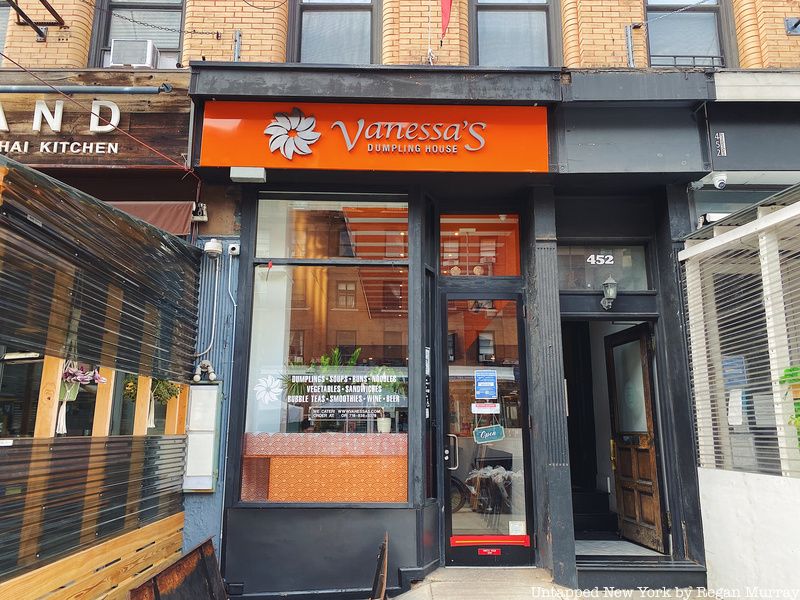 The exterior of Vanessa's Dumpling House, featuring a bright orange sign