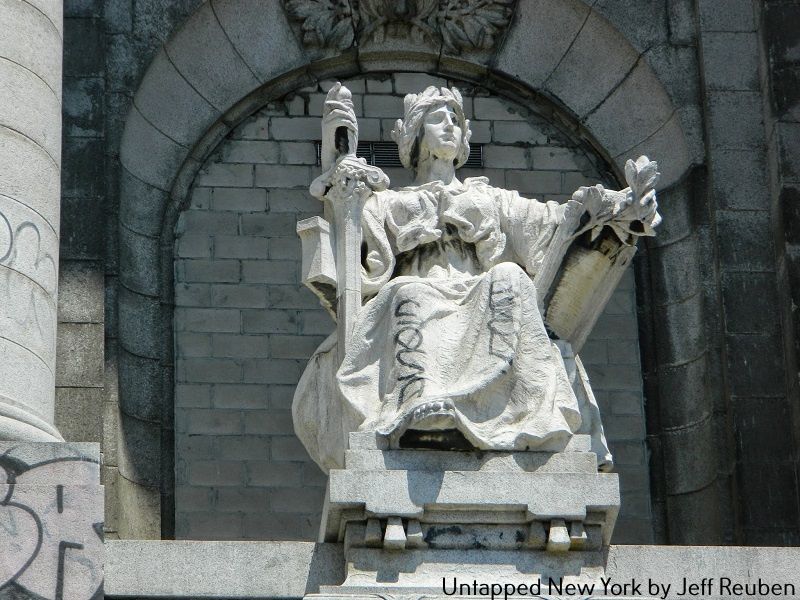 Lady Justice statue with graffiti