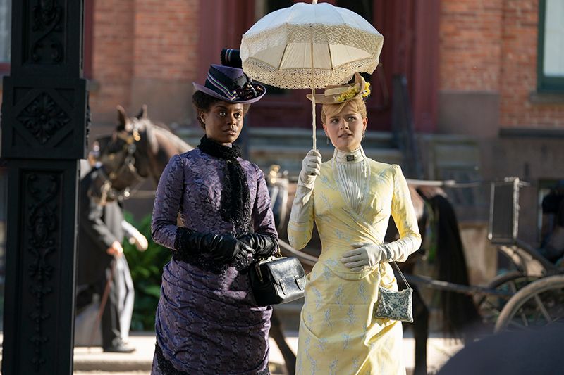 dene benton and louisa jacobson walking into madison square park in the gilded age