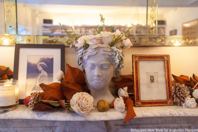 Sculpture and photos atop fireplace mantel