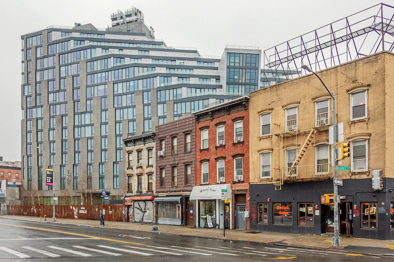 glassy hotel in contrast with older buildings in Williamsburg