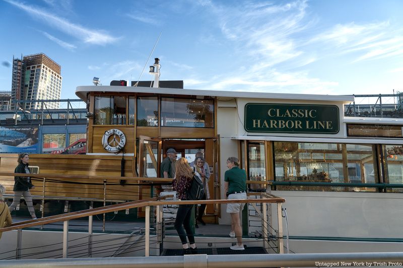 Passengers board a Classic Harbor Line vessel for a climate change boat tour