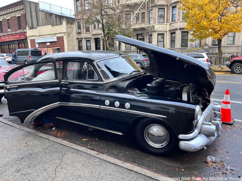 Car door and front hood open on vintage buick car