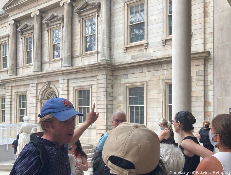 Former museum guard Patrick Bringley talks to a group of tour guests.