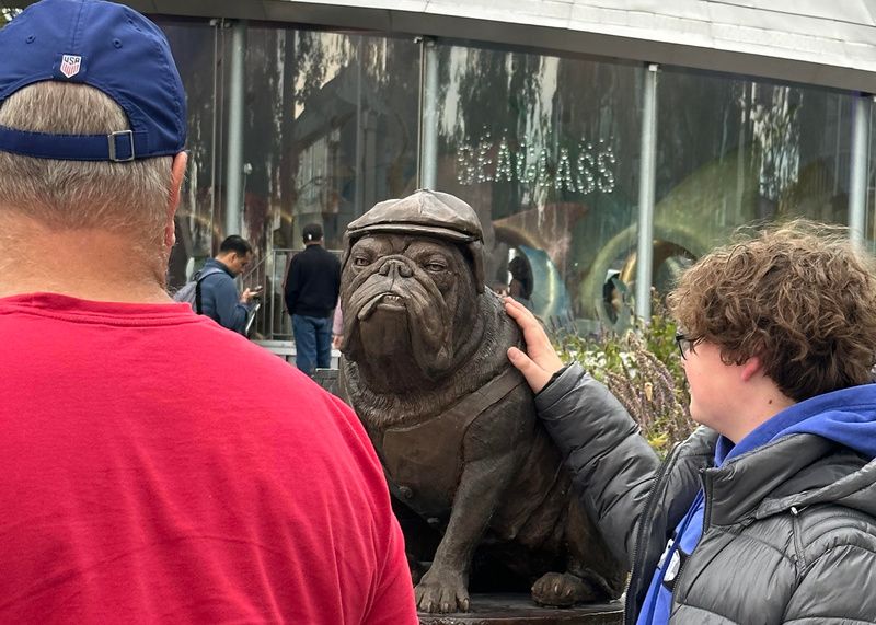 People pet the statue of Porkchop the bulldog bootlegger