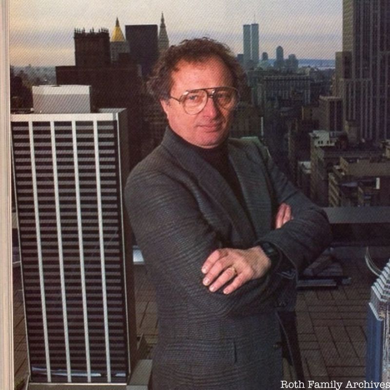 Richard Roth Jr. stands in front of a background of the NYC skyline