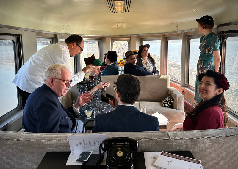 People in period attire inside a historic train