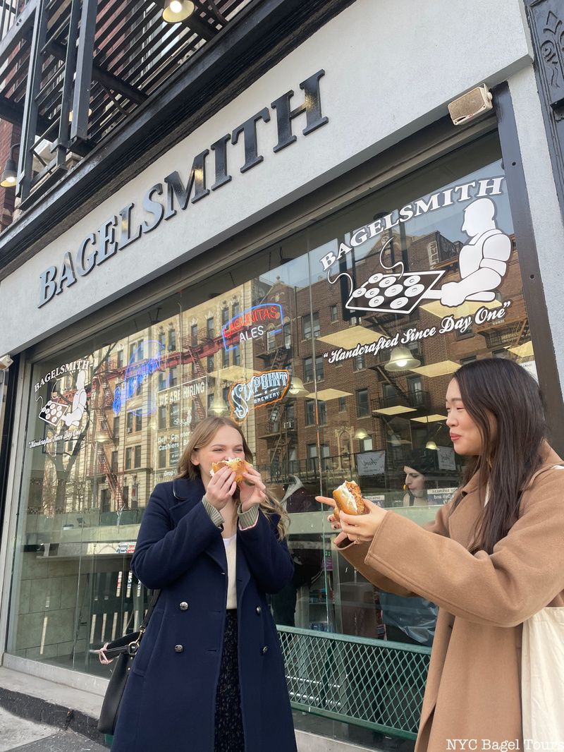 two women eat bagels on an NYC Bagel Tour