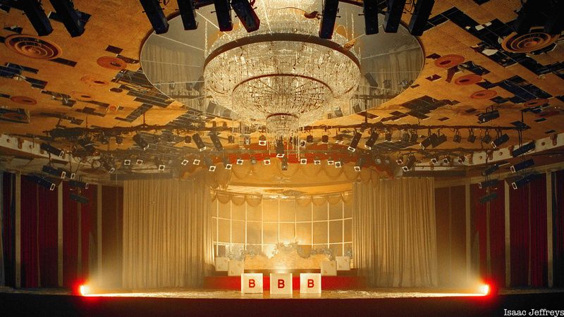 A chandelier hangs above a stage inside an abandoned Borscht Belt resort