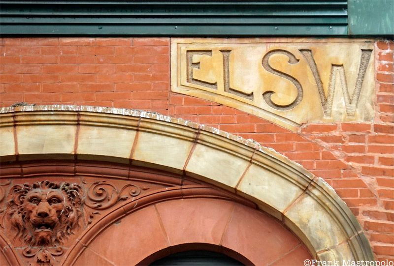 A puzzling ghost sign on a building in Hell's Kitchen reads "ELSW." It is on the Elsworth Building, which was cut in half for new construction.