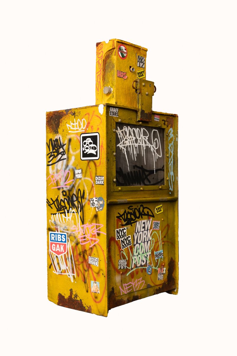 A miniature yellow newspaper box