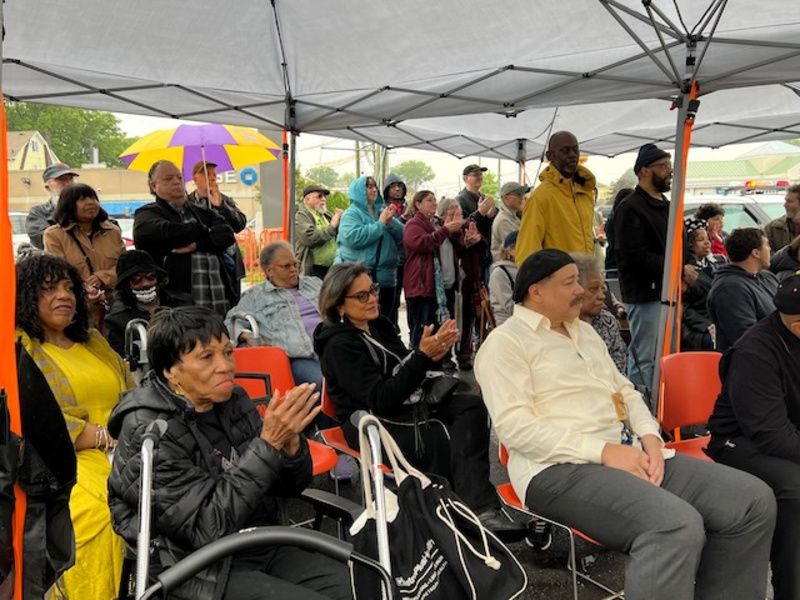 A group of people clapping at the Cherry Lane Cemetery Site