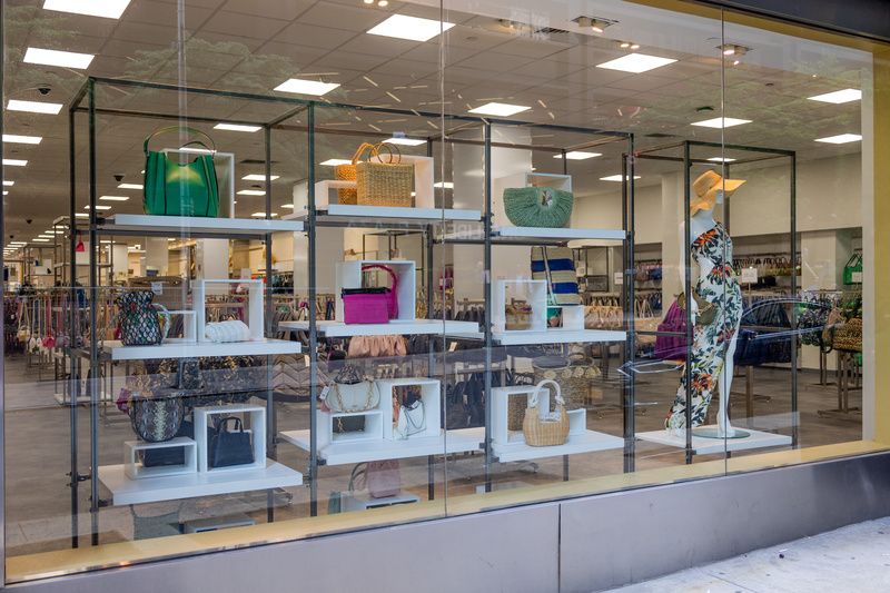 A window display of different colored purses