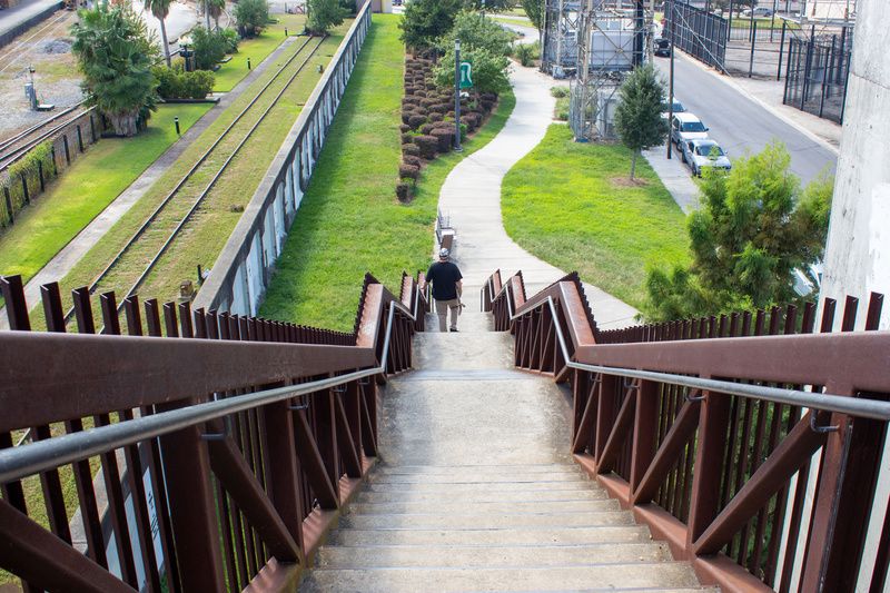 New Orleans Sewage and Water boy walking down a flight of stairs