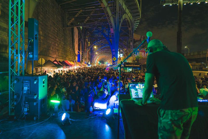 DJ playing for a crowd at the Uptown Night Market in Harlem