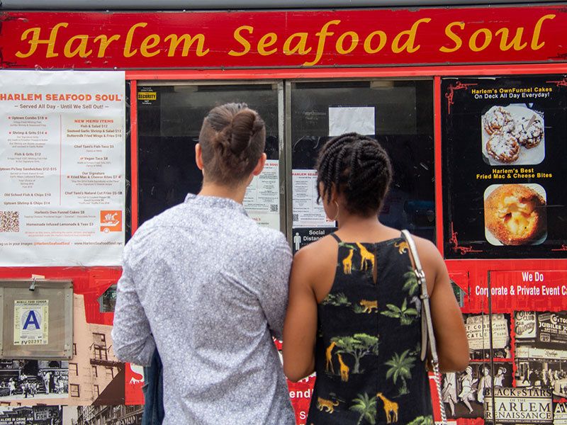 Couple in front of Harlem Seafood Soul food truck