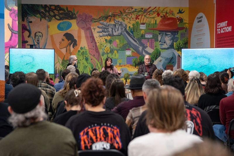 Three people address a crowd at The Climate Museum in NYC