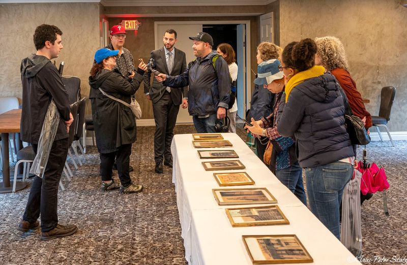 Insiders look at historic images on a long table