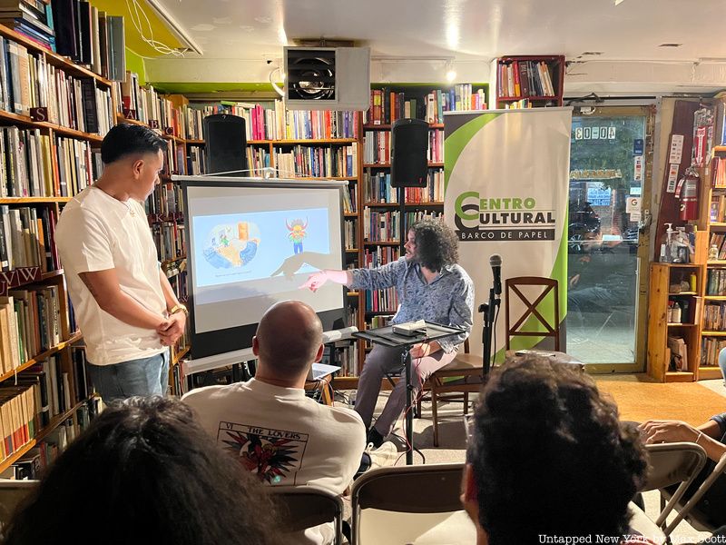 A man gives a presentation inside Librería Barco de Papel bookstore in Queens