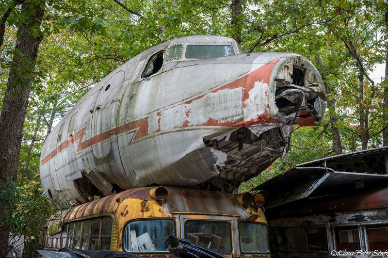 Vintage plane on top of a school bus 