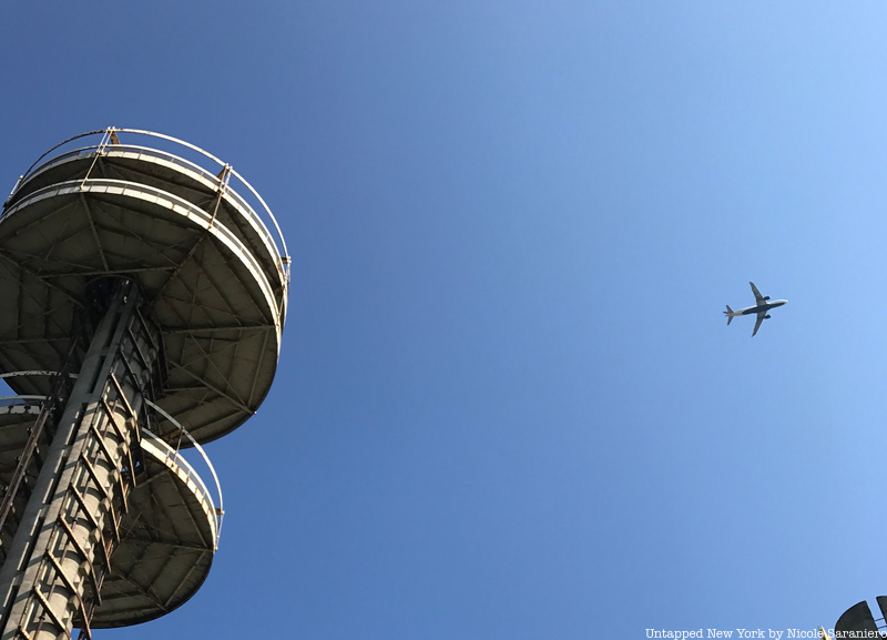 Plane flying over the towers of the NYS Pavilion