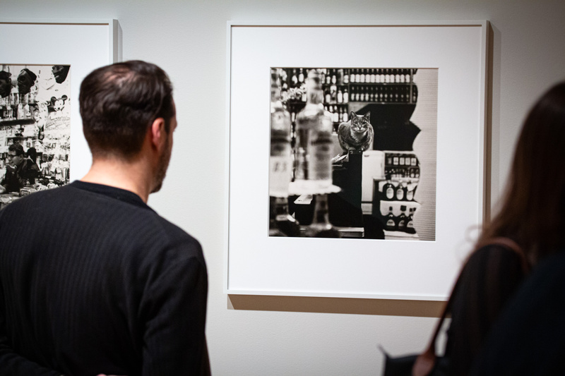 Man looking at a photograph at photographs on the wall of the Peter Hujar exhibit at the Ukrainian Museum