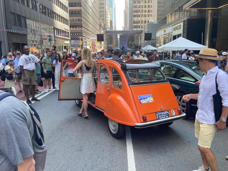 Crowds gathered by Citroen cars