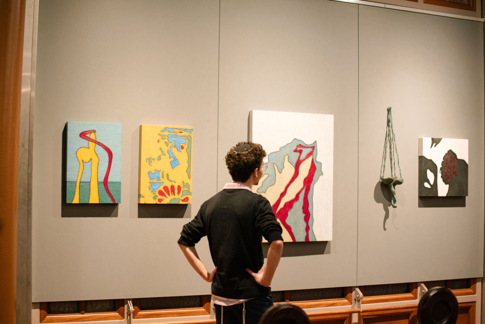 A man looks at Tobi Kahn paintings at the Museum at Eldridge Street