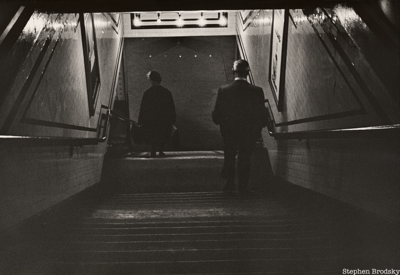 Two people descending an LIRR Staircase