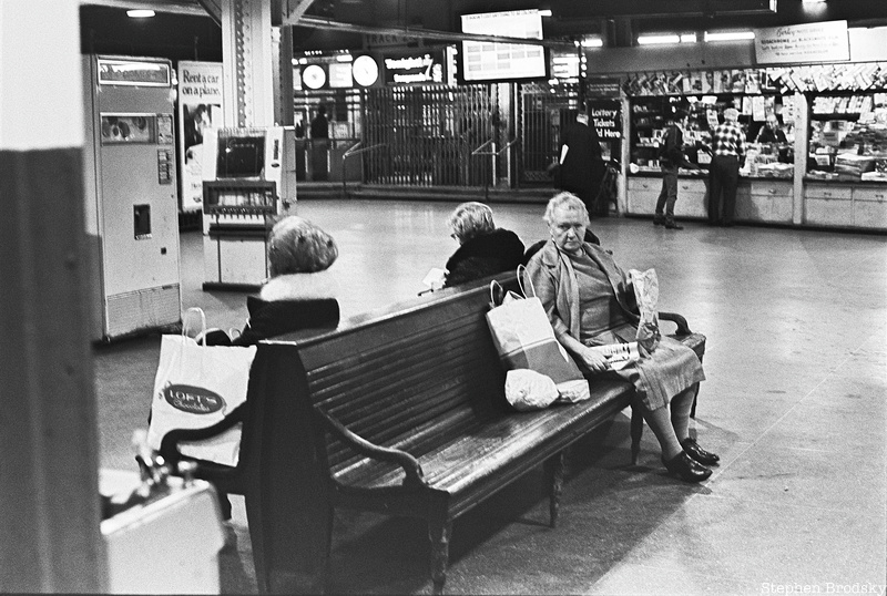 Women sit in a train station waiting room