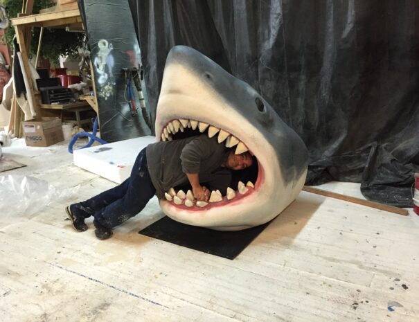 Joseph Reginella inside the mouth of a shark sculpture