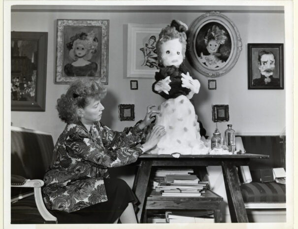 Women works on a large doll figure