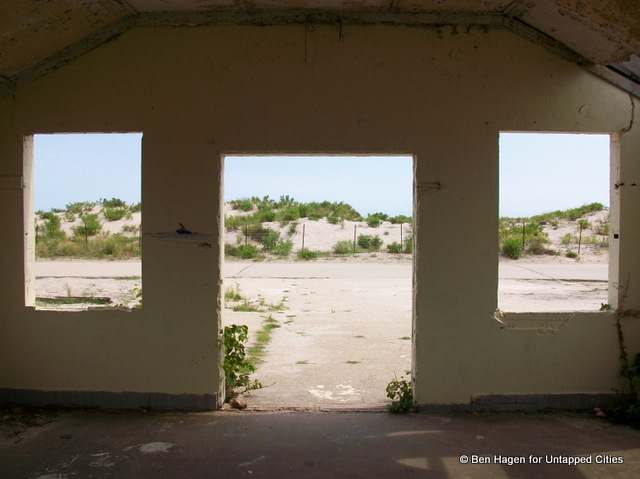 View of sandy hills from inside an abandoned building 