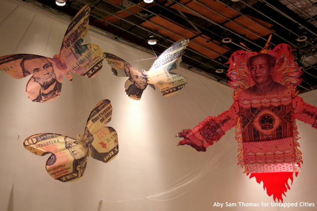 Currency kites, created by Erika Harrsch, hovered over the audience for the debate.
