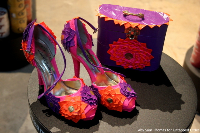 A pair of shoes and a handbag made out of duct tape.