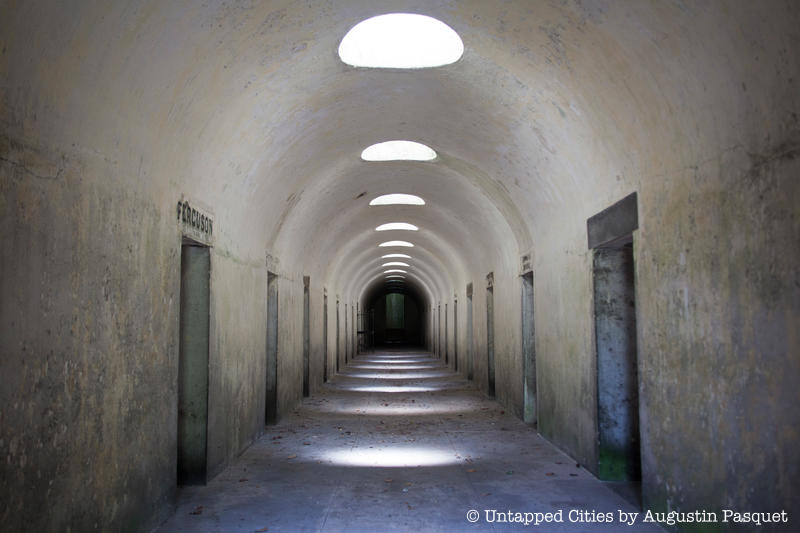 Light peaks through holes in the ceiling of the Green-Wood Cemetery catacombs between rows of doors leading for family burial rooms.