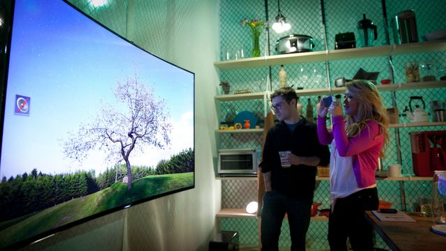 Ogling a curved TV in the kitchen of the future