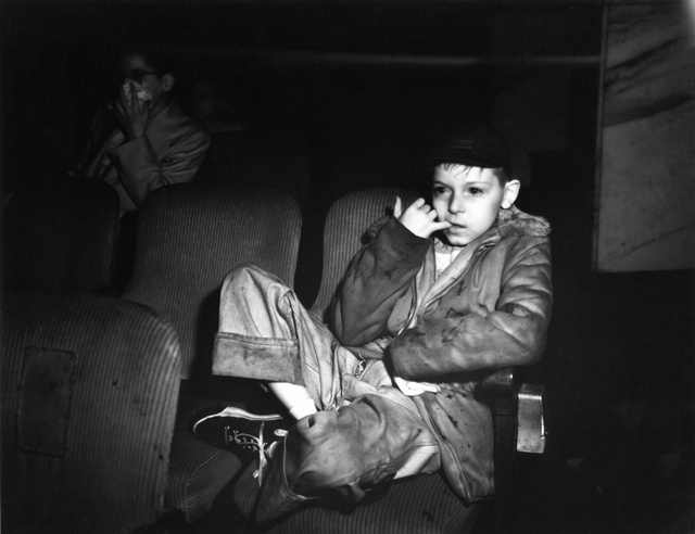 Weegee-Boy-with-finger-in-his-mouth-in-a-movie-theater-International Center of Photography-NYC