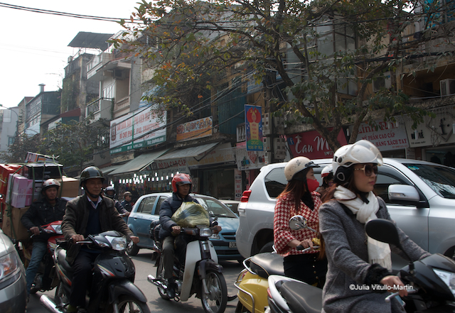 With great panache, motorcyclists negotiate Hanoi's Old Quarter.