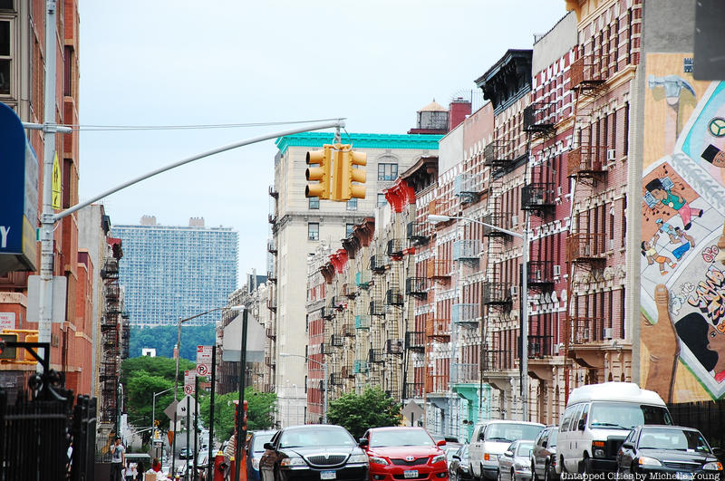 A street of colorful buildings in the micro neighborhood of Little Dominican Republic in NYC