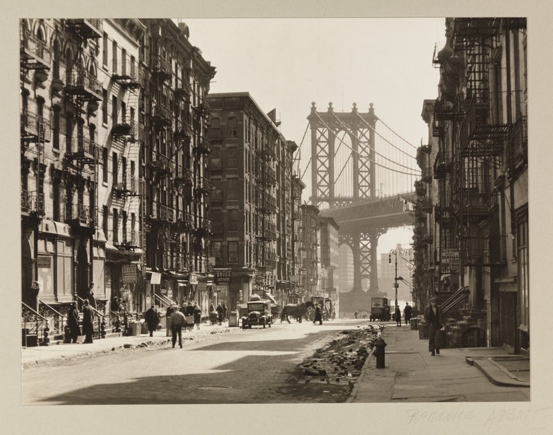 Pike Street between Henry and Madison Streets, showing tenements with the Manhattan Bridge in the background.