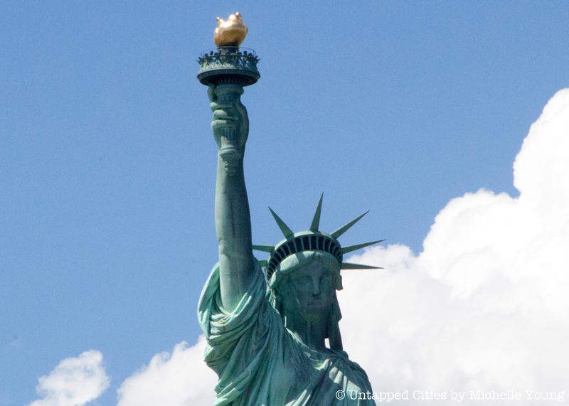 View of the Statue of Liberty's face, crown, arm and torch