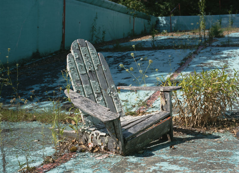 A wooden chair decays in the pool of a Borscht Belt resort