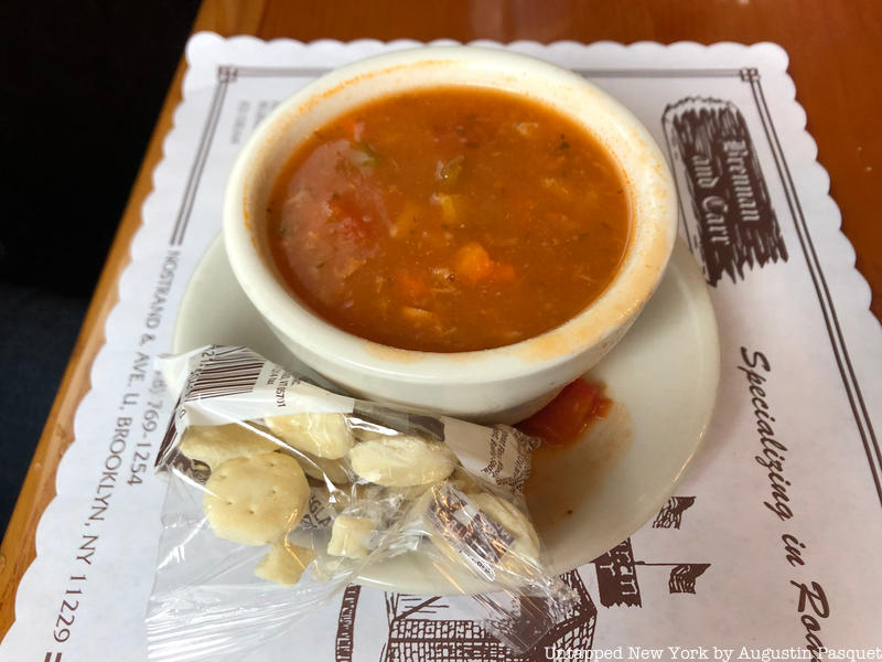 a bowl of clam chowder with a side of crackers
