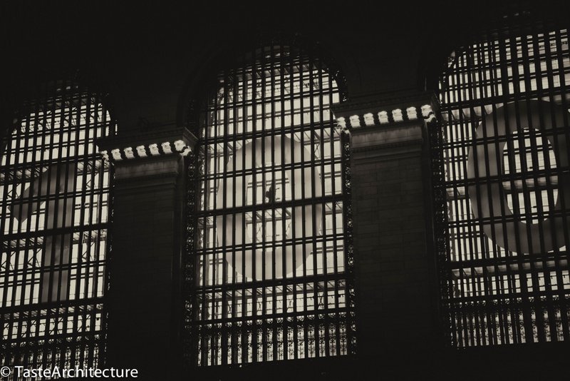 A man passes through the glass walkways in Grand Central Terminal.