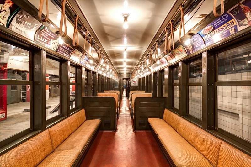 Vintage subway car at the New York Transit Museum with fabric "straphangers". 