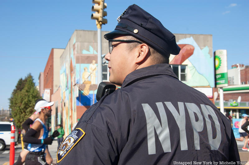 An NYPD officer stands guard at the NYC Marathon