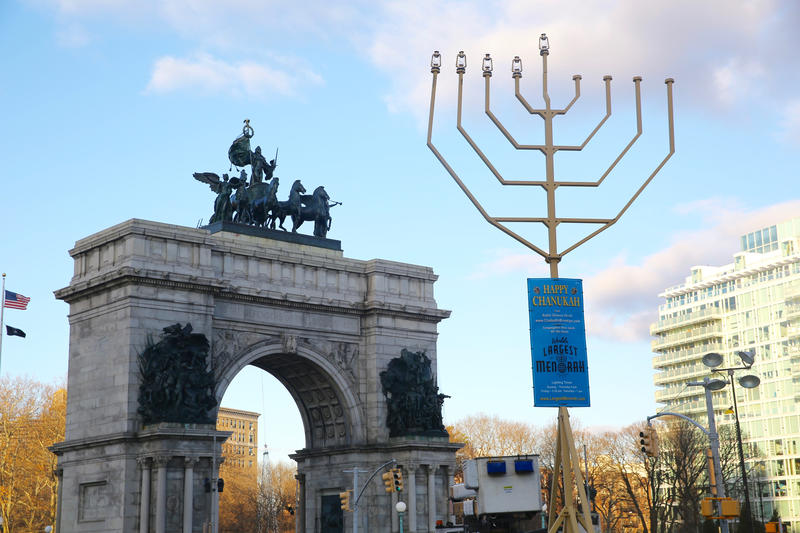 A giant menorah stands in front of Grand Army Plaza