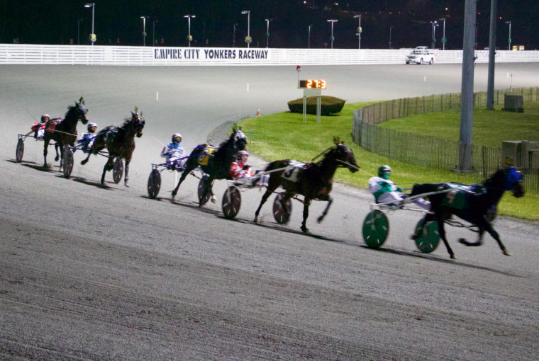 Horses running on the track at Yonkers Raceway